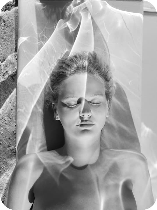 Dreamy portrait with translucent veil evoking hazy softness